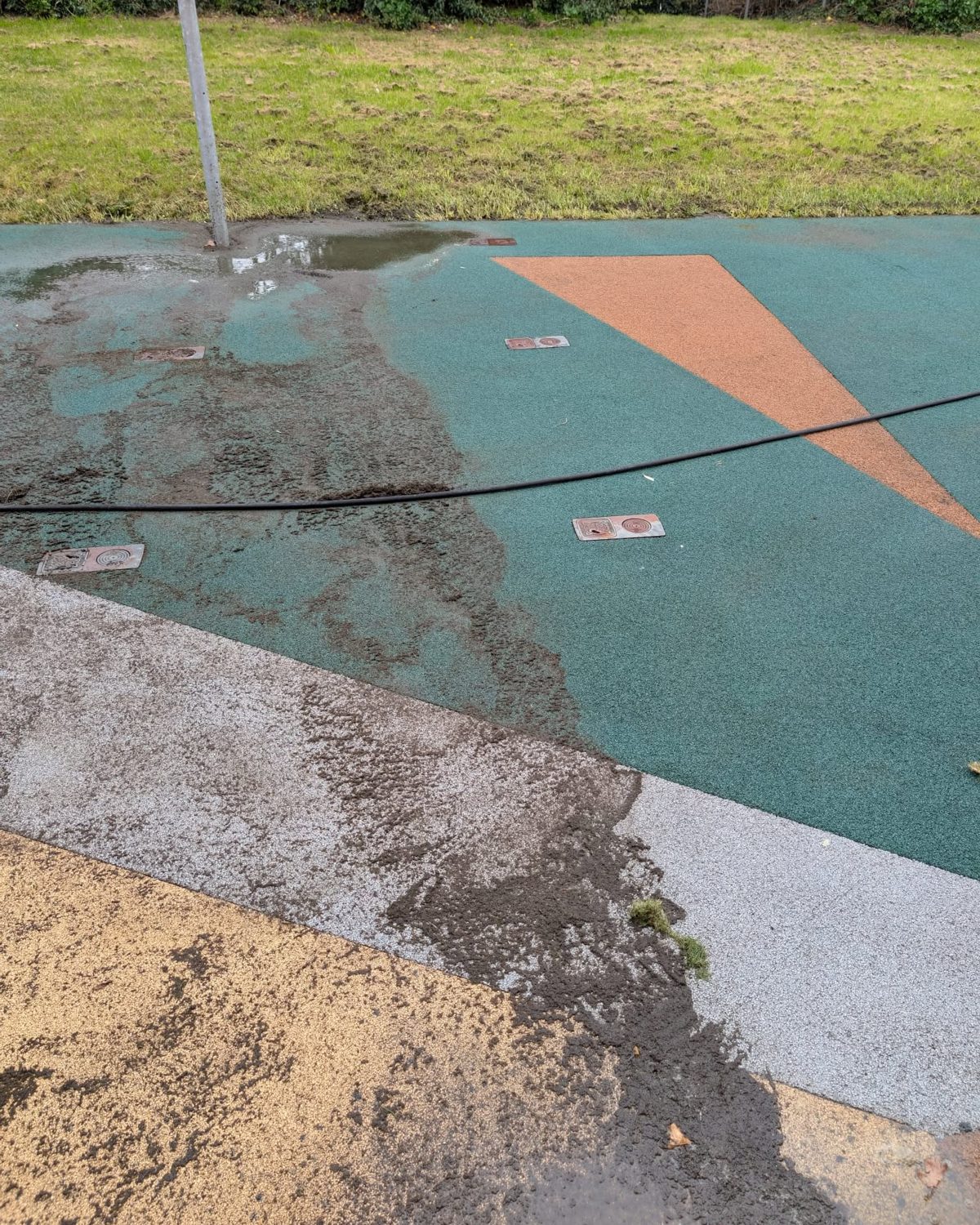 A commercial surface mid-clean - the cleaned strip contrasting sharply with the dirt still to be removed
