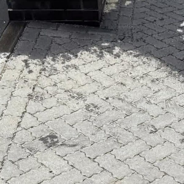 Grey block paving before deep cleaning - blackened with embedded grime